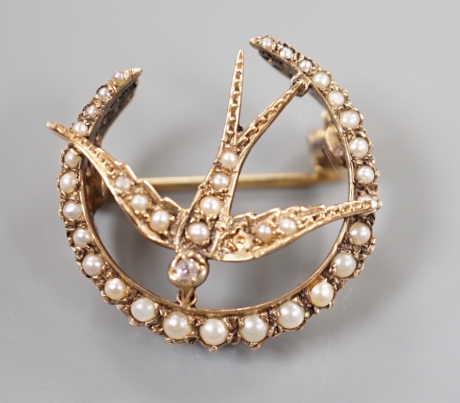 An Edwardian yellow metal, diamond and seed pearl cluster set swallow and crescent brooch, 23mm, gross weight 4.8 grams.